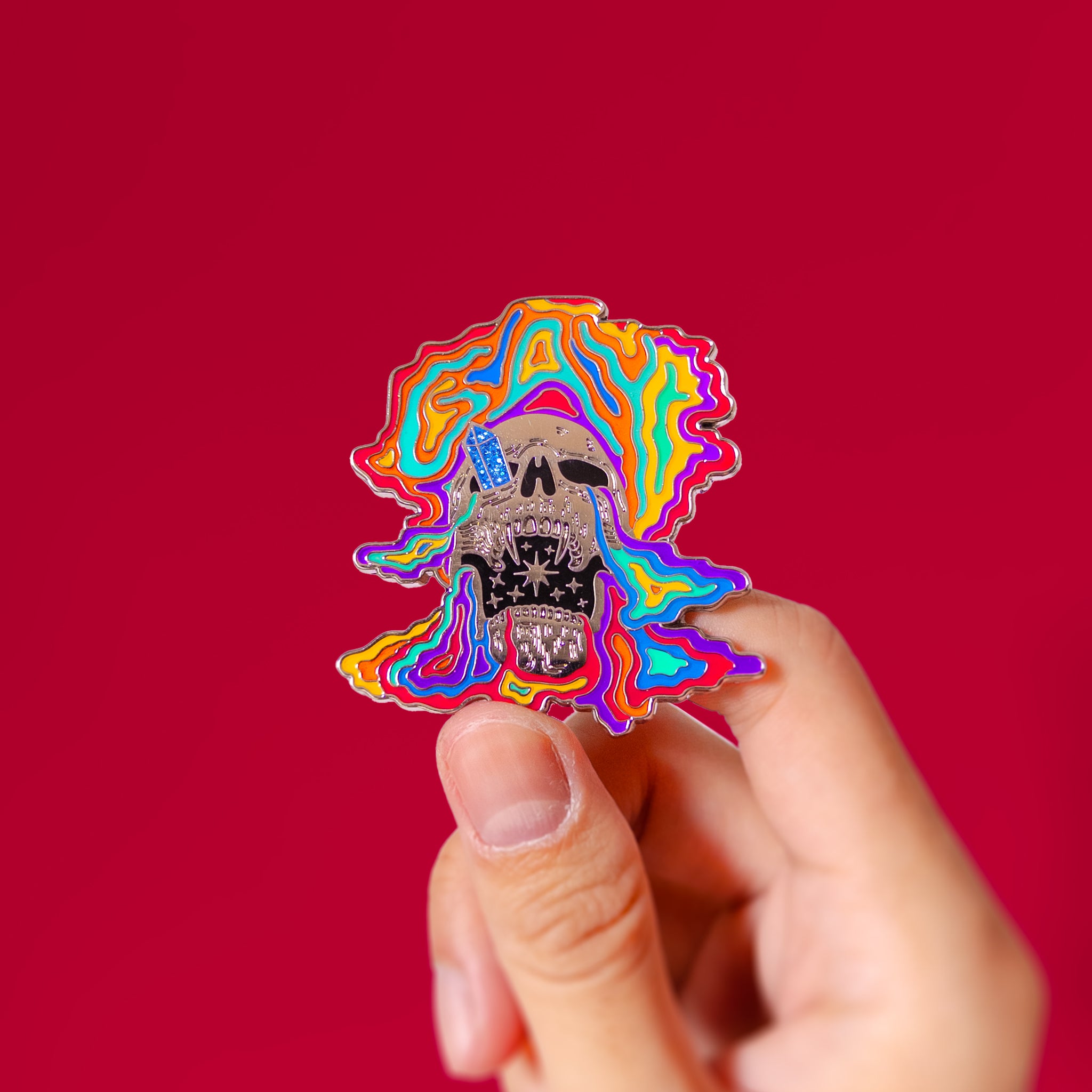 Glow-in-the-dark skull (rainbow) — enamel pin